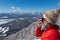 Kobesnock - Woman in hat drinking hot tea with scenic view of snow capped mountain peaks of Julian Alps and Karawanks