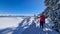 Kobesnock - Woman showing with hiking poles the level of heavy snowfall on the way to Kobesnock in Bad Bleiberg, Carinthia