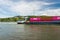 Koblenz, Germany - 1 June 2019. Two connected barges carrying a lot of containers on the Rhine River in western Germany in Koblenz