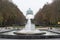 Koekelberg, Brussels Capital Region, Belgium - View over a city fountain, a colorful tree lane and the Basilica of the