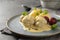 Koenigsberger Klopse or meatballs in a white bechamel sauce with capers, potatoes and beetroot served on a gray blue plate,