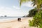 Koh Chang, Thailand - June 2019: Thai man walking an elephant on sandy Long Beach