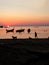 Koh Tao, Thailand - November 2018: Man and dog playing in the beack during a beautiful sunset, Koh Tao, Thailand