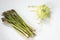 Kohlrabi, also known as german turnip, and a bunch of asparagus. White background, Flatlay