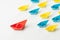 KOL, key opinion leader, micro influencer or leadership concept, big red origami paper ship leads in front of others small yellow