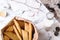 Kolakakor - swedish cookies, bottle of milk and candle and pine cone on grey marble table