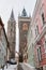 Kolin, Czech Republic, 17 December 2022: Medieval stone St. BartholomewÂ´s Church with tower under snow in winter day, arched