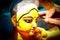 Kolkata; India - Asia; An artist gives final touches to idol of hindu Goddess Durga in workshop made of Plaster of Paris Clay at