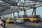 Kolkata, India - February 2, 2020: Yellow classic taxis, colorful public transport buses and cars drives over Howrah bridge