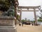 Komainu statue in front of Torii gate at Itsukushima Shrine, Hiroshima, Japan