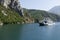 Koman, Albania, July 7 2019: An oncoming ferry at a narrow spot on the Komani Lake in the Dinaric Alps of Albania