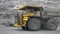 A Komatsu 730e dump truck drives through a quarry.