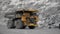 A Komatsu 730e dump truck drives through a quarry.