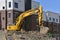 Komatsu excavating machine on earthen mound