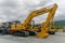 Komatsu PC210 excavator and other mining equipment stand at the base.