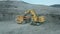 Komatsu PC4000 excavator loads ore into a BelAZ dump truck at the coal mining site.