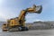 A Komatsu PC4000 excavator moves with a raised bucket in an open pit.