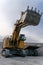 A Komatsu PC4000 excavator moves with a raised bucket in an open pit.