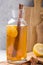Kombucha or cider fermented drink. Cold tea beverage with beneficial bacteria, cinnamon, lemon on concrete  background side view