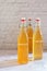 Kombucha in glass bottle on white table, fermented tea drink,