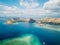 Komodo - A drone shot of a paradise island with some boats anchored around