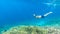 Komodo - A man snorkelling on a coral reef