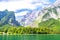 Konigssee lake with clear green water, reflection, mountains and sky background, Bavaria, Germany