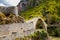 Konitsa city arced bridge and voidomatis river in autumn , greece