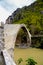 Konitsa city arced bridge and voidomatis river in autumn , greece