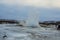 Konungshver geyser steams- Strokkur geyser erupts in the background, in Iceland