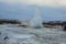 Konungshver geyser steams- Strokkur geyser erupts in the background, in Iceland