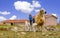 Konya, Turkey-April 14 2019: Ewe female sheep with newborn twin lambs in green meadow near a barn in spring time, Konya, Turkey