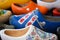 Koog aan de Zaan, Netherlands. July 2022. Colorful clogs against the background of a wooden wall. Popular souvenirs