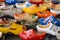 Koog aan de Zaan, Netherlands. July 2022. Colorful clogs against the background of a wooden wall. Popular souvenirs