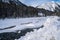 The Kootenay River in Kootenay National Park is covered in snow and ice during winter. Taken near Numa Falls waterfall