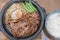 Korean Barbecued Pork in hot pan with egg, sprout and peas on si