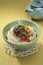 Korean Bulgogi Kimchi Udon in bowl with tea pot on the table