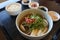 Korean clams soup with tofu and onion on wooden tray with rice