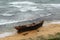 Korean fishing boat wreck on sandy sea beach after the storm. Broken boat of poor north korean fishermen.