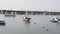 Korean fishing trawler crossing  small port under overcast sky