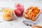 Korean kimchi cabbage, beet sauerkraut and sauerkraut in glass jars, white background