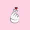 Korean love sign on a pink background, fingers and heart