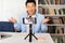 Korean Male Teacher Video Calling Using Cellphone On Tripod Indoor