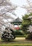 Korean Pavillion behind blooming trees.