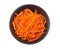Korean pickled carrots salad in black bowl isolated on white background. top view