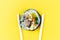 Korean rolls gimbap wooden sticks on yellow background close-up