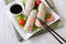 Korean spring rolls with shrimp and sauce on a plate horizontal