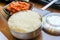 Korean style food Kimchee sour spicy vegetable pickled and rice bowl with on wood table background