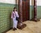 Korean tourist with mosaic tile and marble pillars inside the Hassan II Mosque Museum in Casablanca, Morocco.