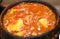 Korean traditional Kimchi soup in a clay pot against wood background